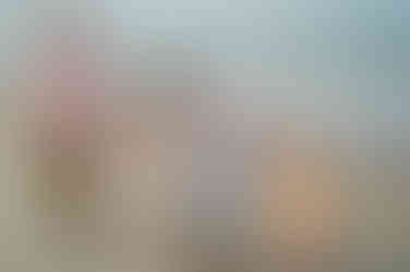 family holding hands and walking towards the camera on Daytona beach,