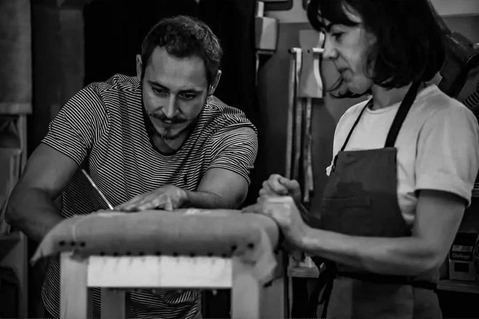 Armand Verdier demonstrating traditional upholstery techniques