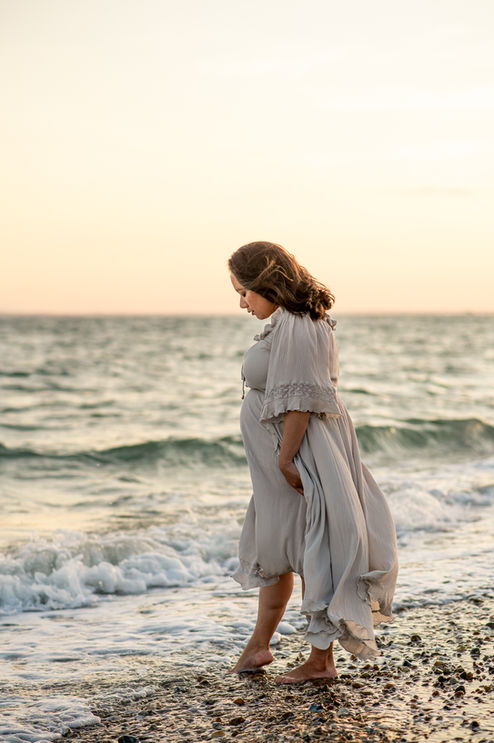 pregnant lady on the beach during maternity photoshoot with maternity Photographer Rachel Fairfield Photography