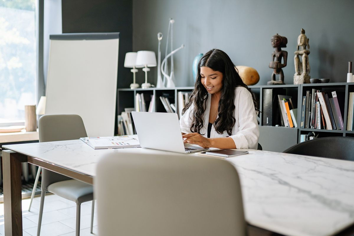 Professional reviewing startup bookkeeping software at a modern desk