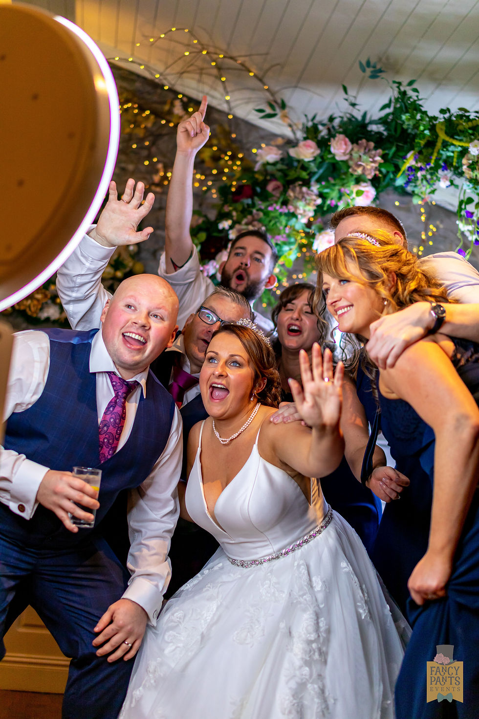 Wedding guests laughing and posing together at the Fancy Pants Events photo booth