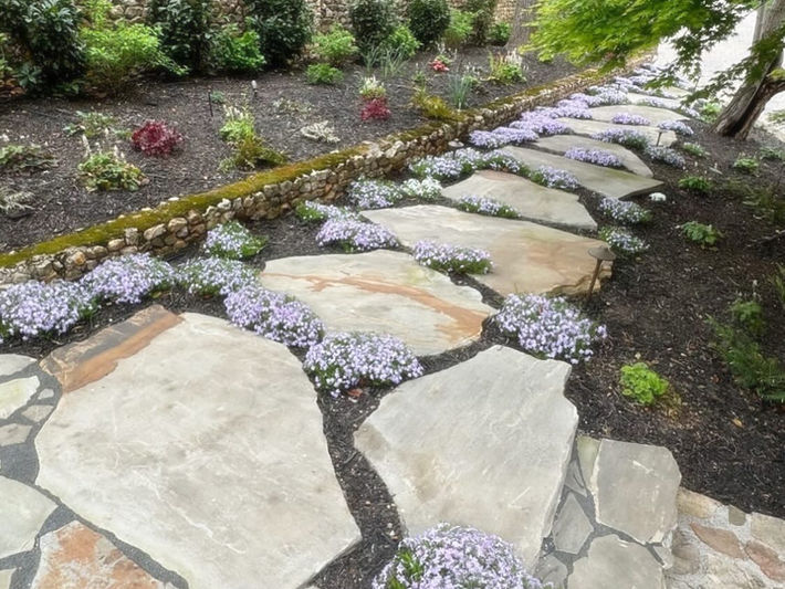 Garden path with large flagstones and flowers