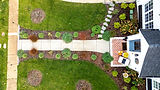 Geometric landscape design with shrubs, walkway, flower beds