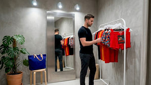 Man browsing men's underwear in boutique fitting room