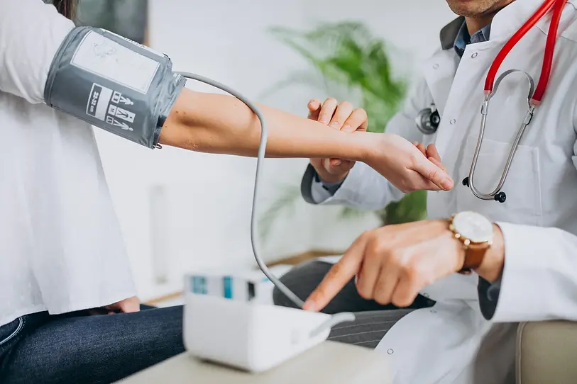 young-male-psysician-with-patient-measuring-blood-pressure-3-scaled.webp