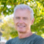 positive-mature-man-with-crossed-arms-standing-outside-smiling-vertical-shot-mature-sporty