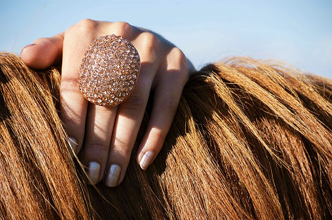 This ring is a real show-stopper. This massive ring from Le Chateau packs more than a little bling with its beautiful rose-gold finish encrusted with matching rhinestones.