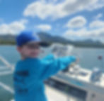 child steering a boat in Costa Rica