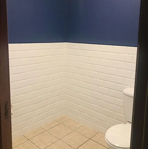 Renovated half-bath with blue and white walls