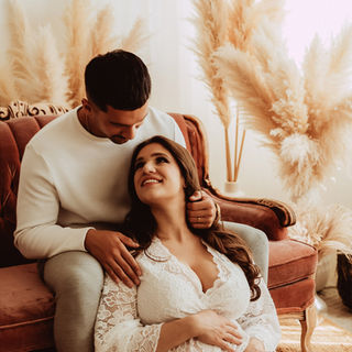 Calgary-maternity-photography-couple-sitting-near-loveseat