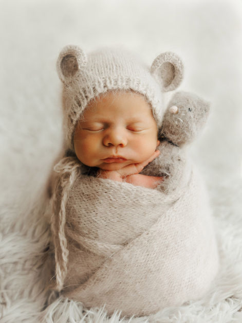 newborn photography calgary baby in potato sack pose with cat stuffy