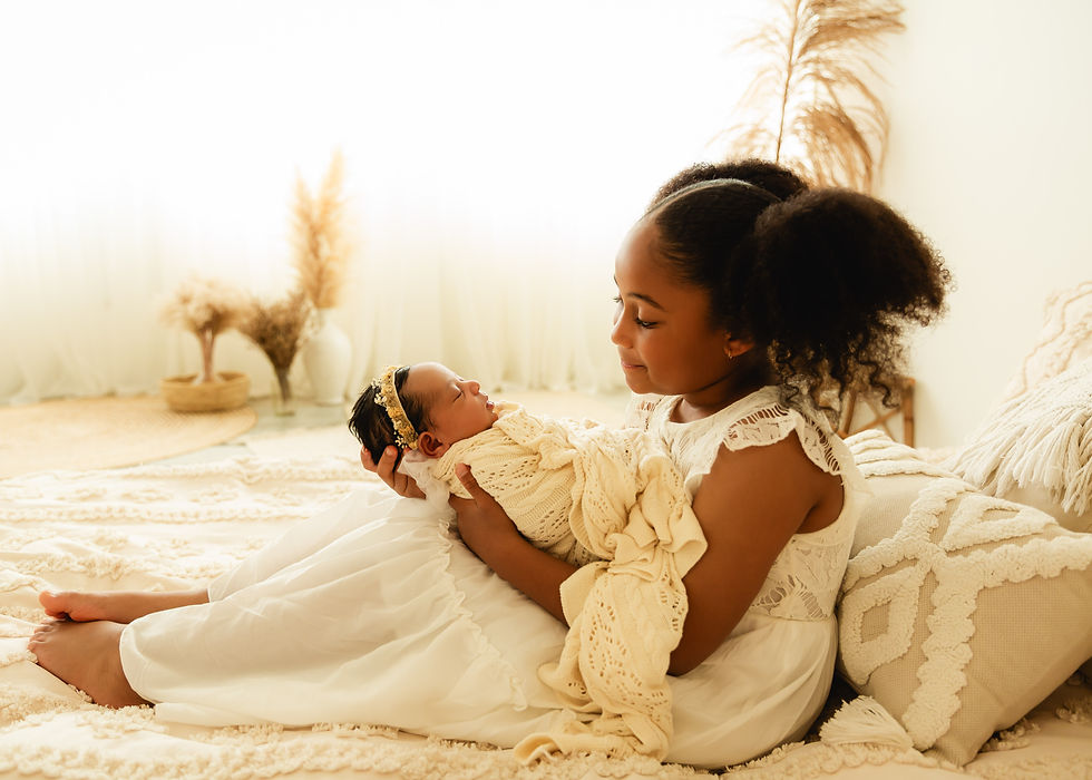 newborn photography calgary sister holds baby