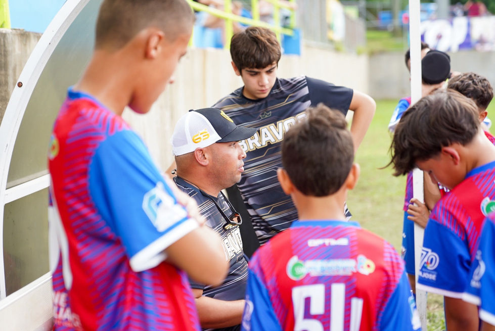 Entrenador habla con equipo Bravos de Cidra en campo de fútbol. Categorías Masculinas