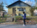 Young man standing in front of a home
