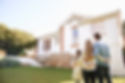 welcome-home-family-standing-outdoors-admiring-their-new-home.jpg