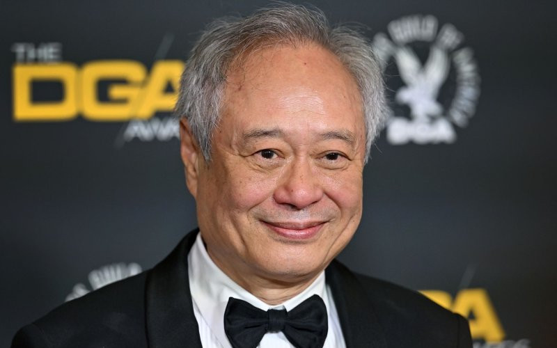 “Film director in a black tuxedo and bow tie smiling on a Directors Guild of America awards red carpet.”