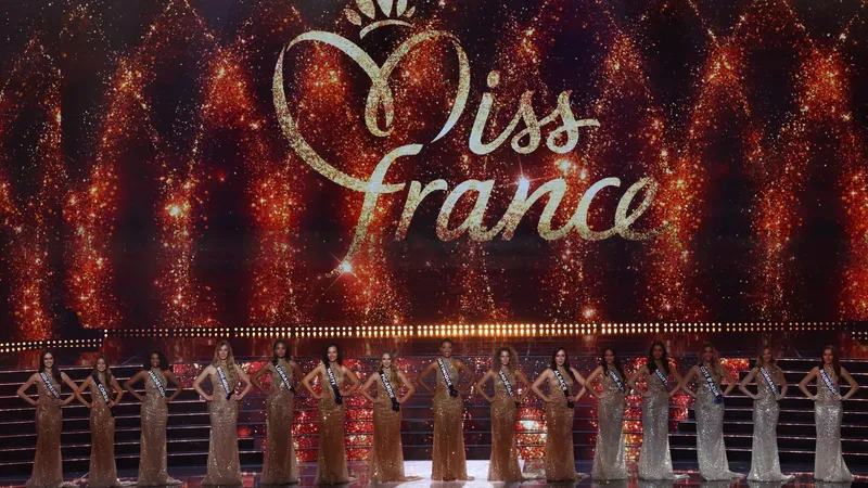 The 30 official Miss France 2026 candidates posing in matching pink dresses and sashes for their portrait release.