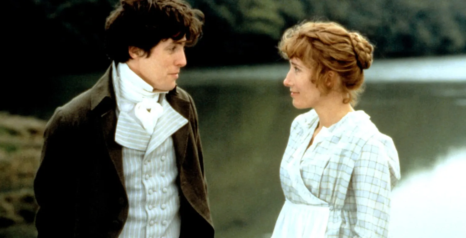 “Scene from ‘Sense & Sensibility’ with two characters in Regency-era dress standing by a lake, facing each other in quiet conversation.”