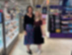 Emily Miller and Kerry Smith of Niche Magazine smile inside the brightly lit makeup store of Boots Fosse Park. Shelves display cosmetics. Visible text: Urban Decay. Cheerful mood.