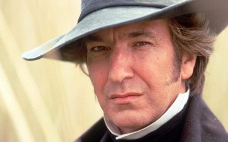 “Portrait of a man in period costume and wide-brimmed hat, staring intently at the camera in a still from a historical drama.
