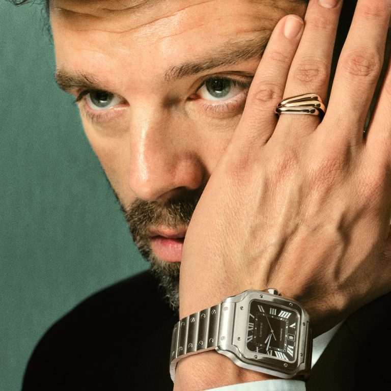lose-up of Sebastian Stan’s wrist wearing the Santos de Cartier,