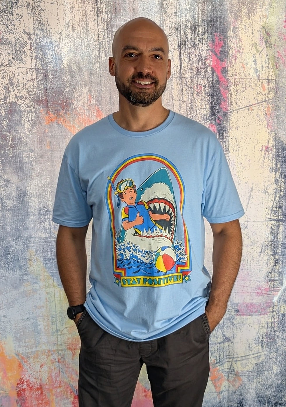 Steven Rhodes – “Stay Positive!” Light Blue Unisex T‑Shirt