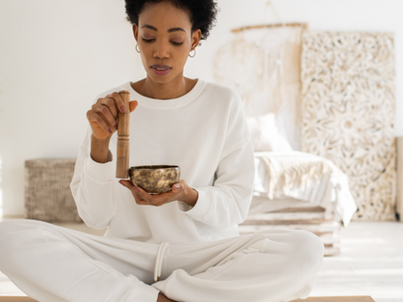Woman using sound bowl for healing