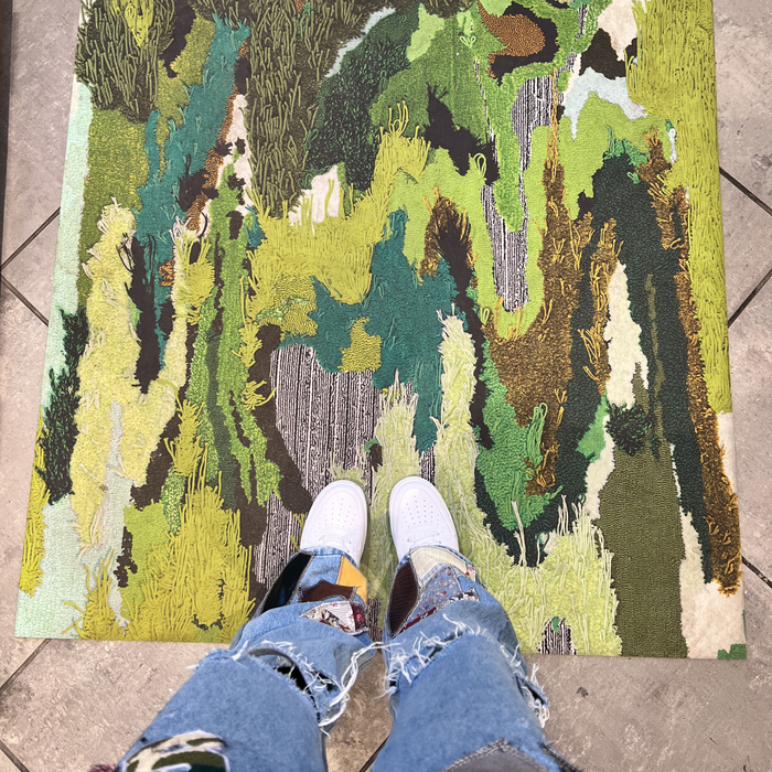 Art on Starr while standing on art; pants designed by Front Paije