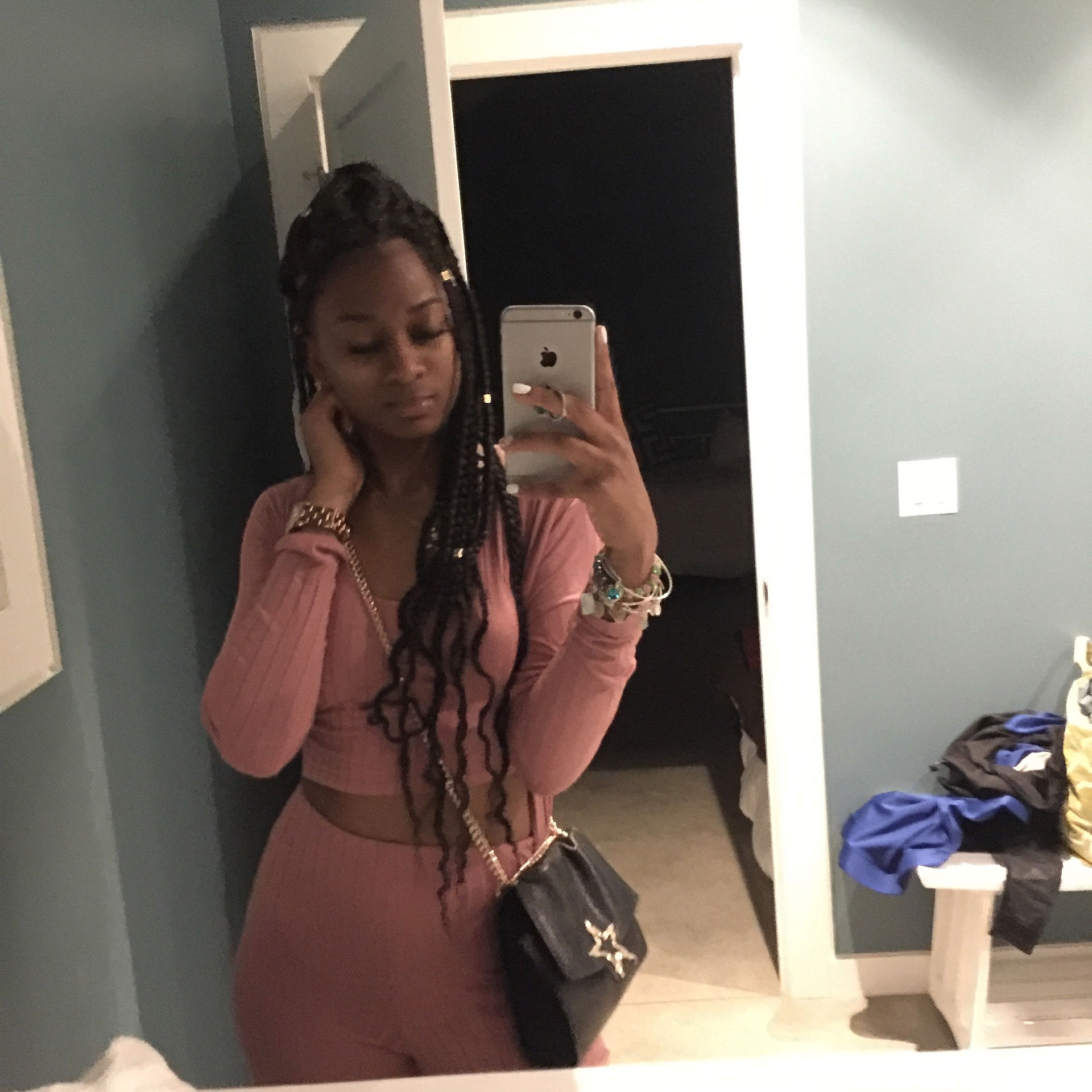 Starr in a pink fashion nova 3pc set with her black leather handbag with gold chains and a gold star in front