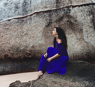 Woman Sitting on Stone