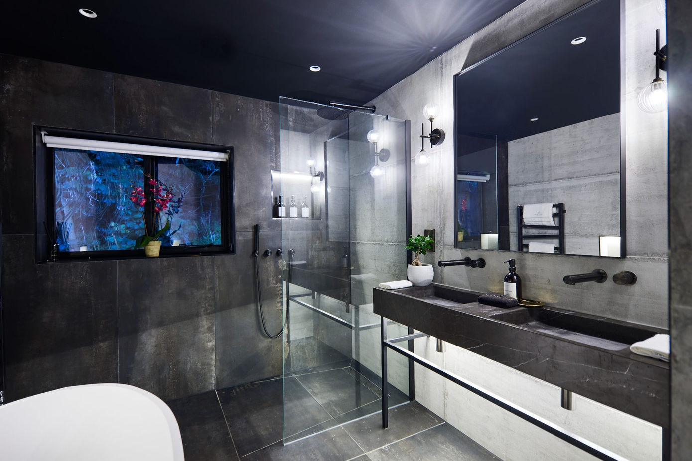 Modern bathroom with a freestanding tub, glass shower, and double vanity.