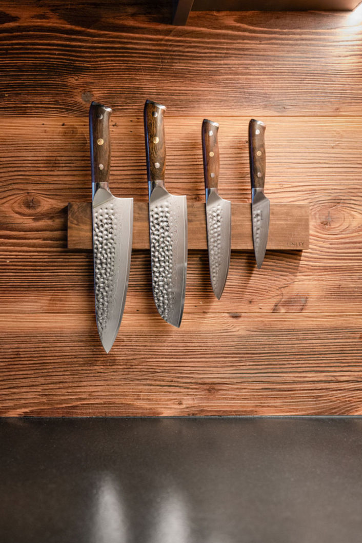 Kitchen with black granite surfaces, handle-free cabinetry, and modern Alpine aesthetics