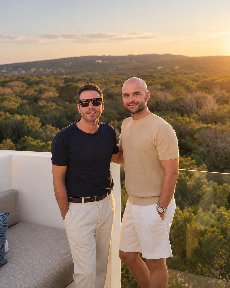 Two men standing together outdoors during sunset.