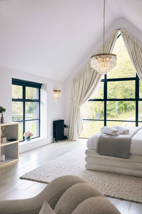 Spacious bedroom with A-frame ceiling and scenic view
