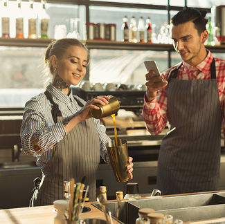tv production agency - Two-Bartenders-Recording-Tutorial-Video-On-Smartphone-At-Coffee-Shop