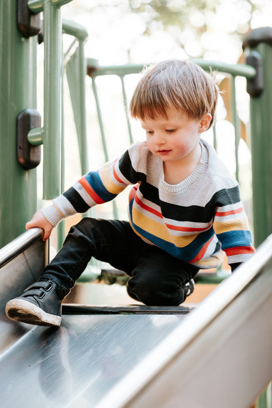 boy at top of slide