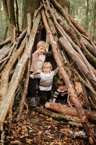 children around woodland tipi