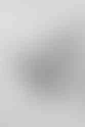 Close-up newborn baby details including tiny feet and soft hair in natural light studio photography session