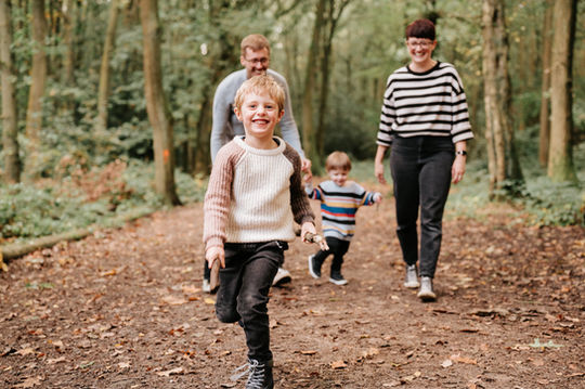 family walking through woods