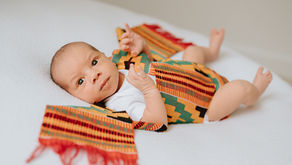 Newborn wrapped in traditional cultural fabric