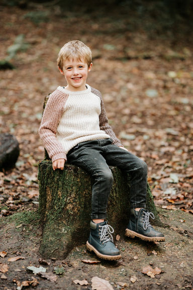 boy sat on tree stump
