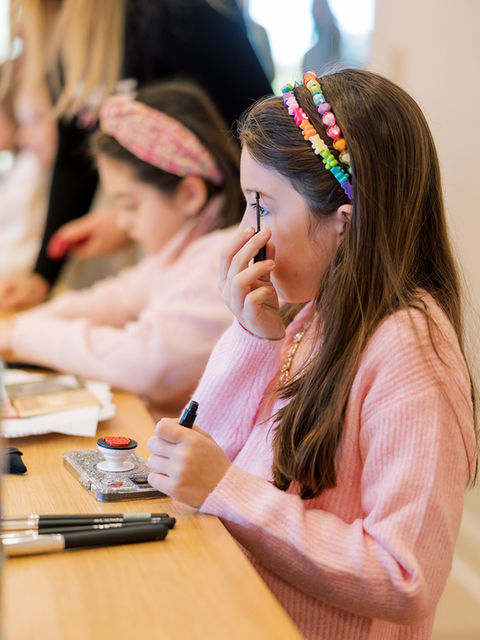 Girl applying makeup at Glam Parties