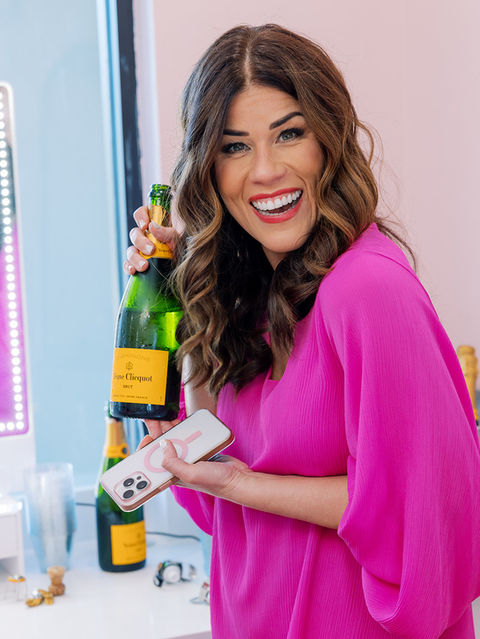 Mom holding bottle of champagne at glam party