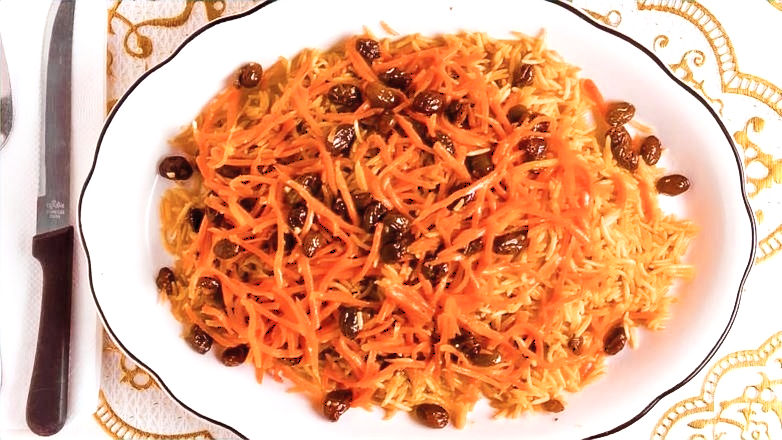 Eye-level view of a plate of Kabuli Pulao, a famous Afghan dish