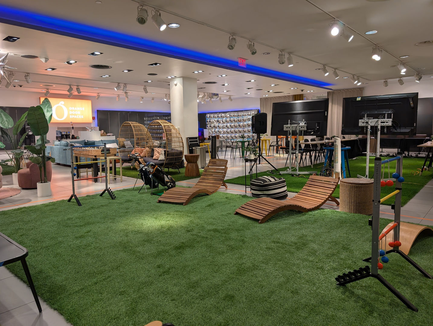 Event space with green turf and various furniture for Hourly Rental Spaces.