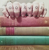 photo of the artist's hands and books