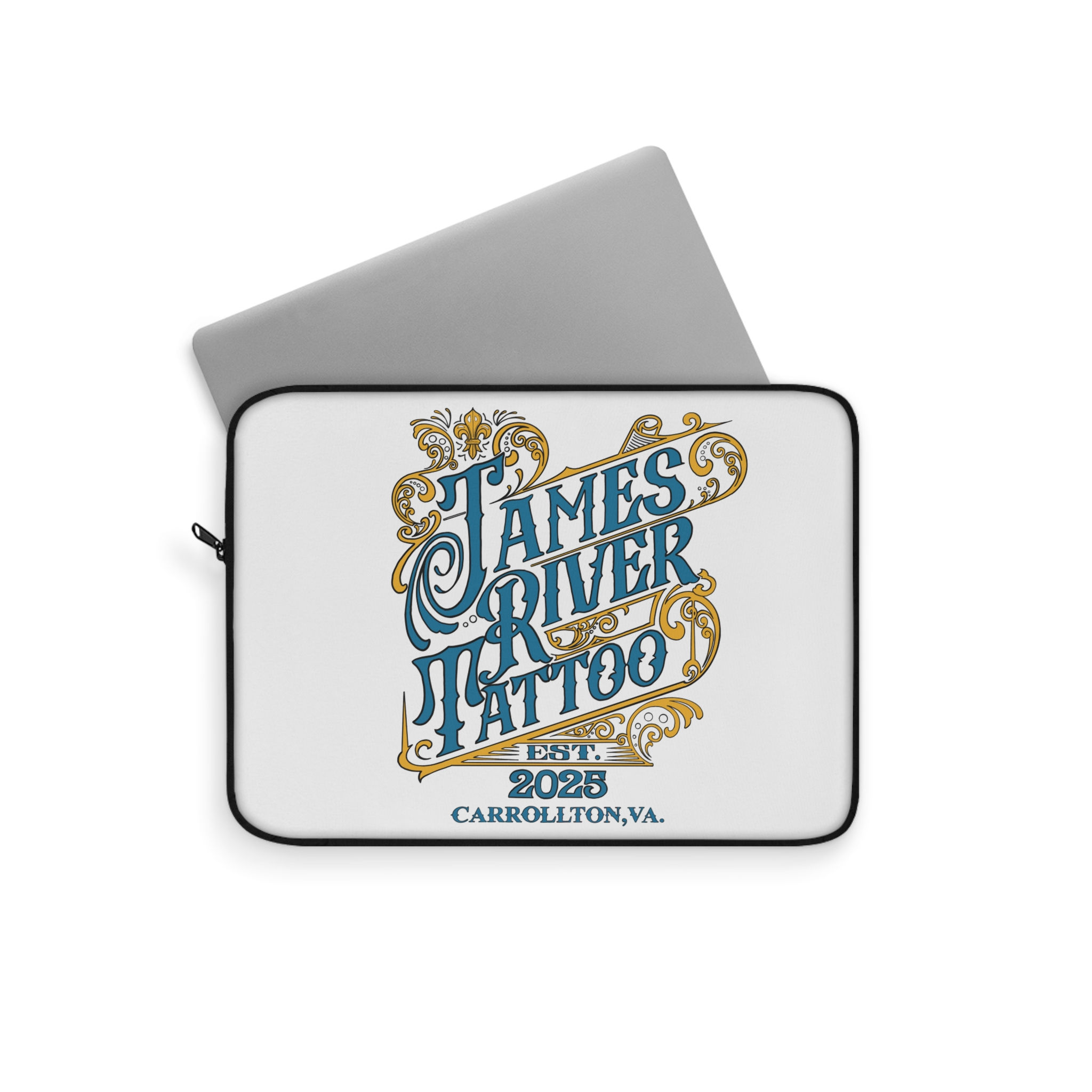 View of a laptop sliding into the James River Tattoo vintage logo tech sleeve.