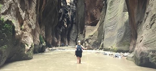 Virtuoso advisor Amy Kilbreath hiking the Narrows in Zion National Park on a luxury vacation