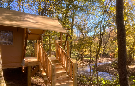 safari tent with water view, glamping