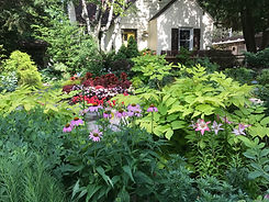 flowering front garden of a yellow home